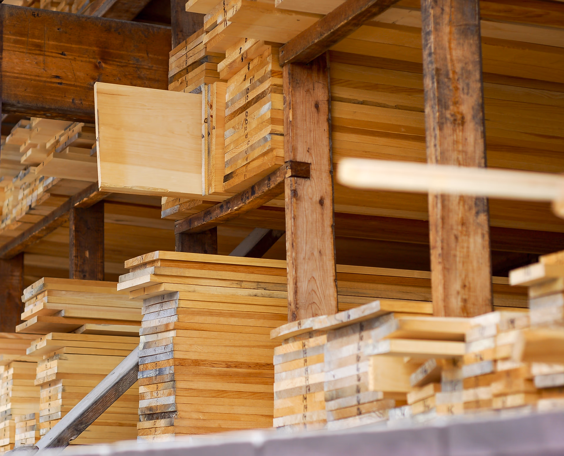 Stacked lumber boards at the Amish wood mill where buildings are hand-built