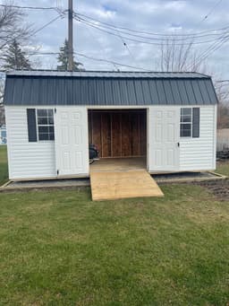 Amish-built lofted garden shed with vinyl siding at a customer property in Southern Michigan