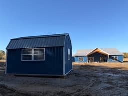 Amish-built lofted garden shed with metal siding at a customer property in Southern Michigan