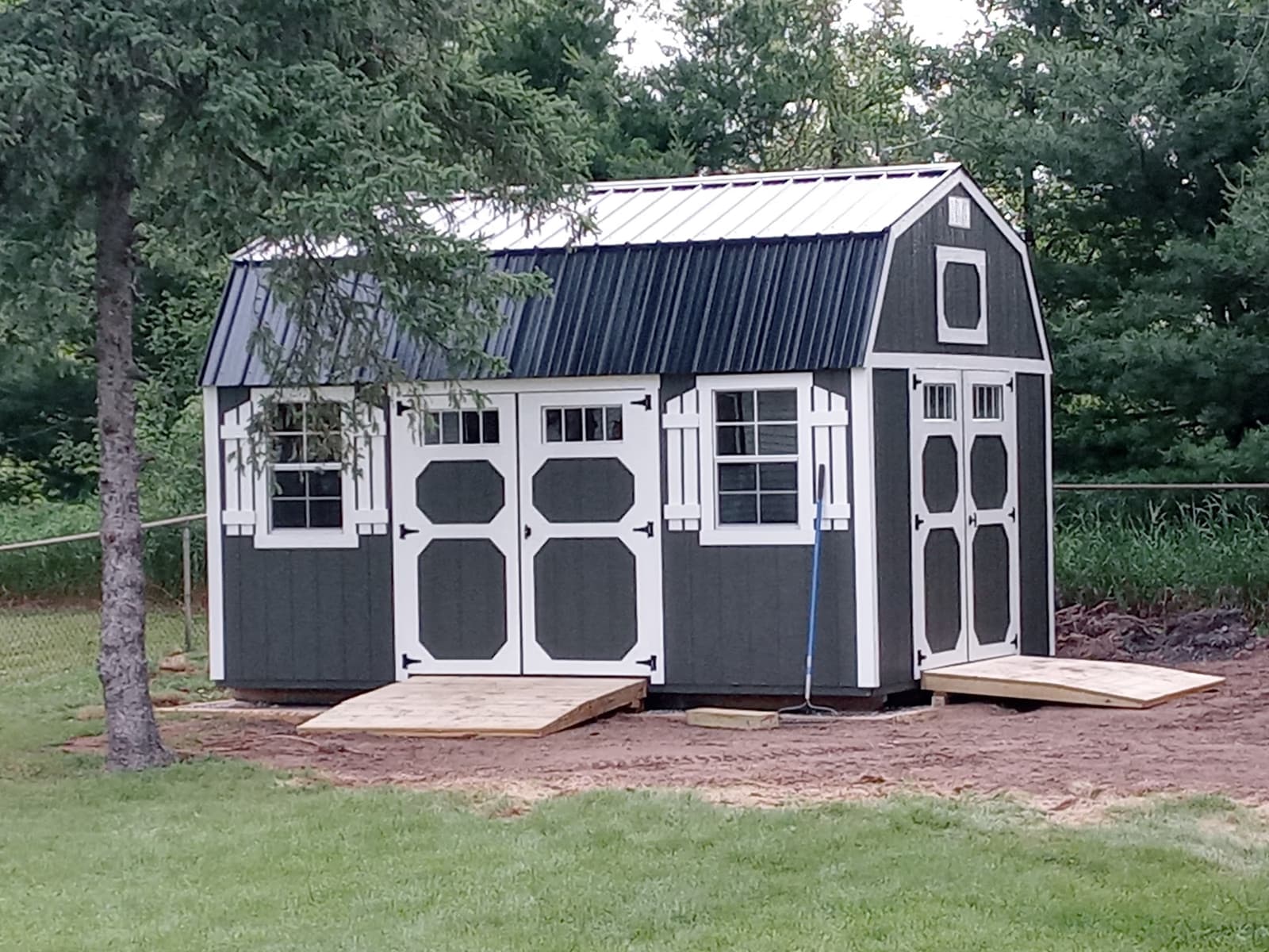 Customer lofted garden shed in a wooded backyard