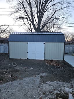 Amish-built lofted garden shed with metal siding at a customer property in Southern Michigan