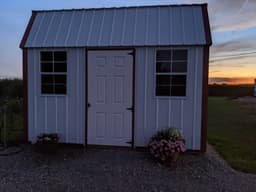 Amish-built lofted garden shed with metal siding at a customer property in Southern Michigan