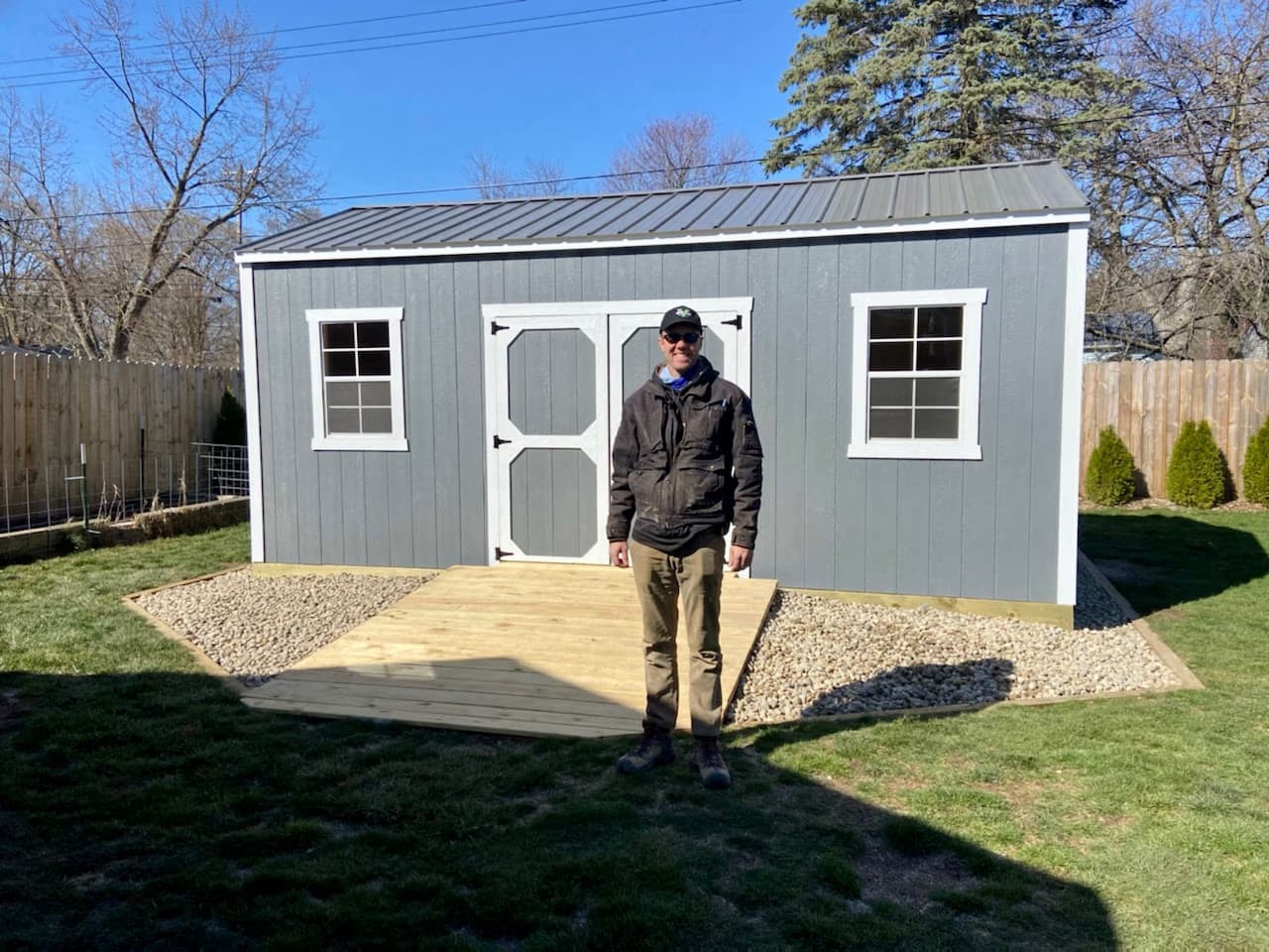 Happy customer receiving delivery of an Amish garden shed