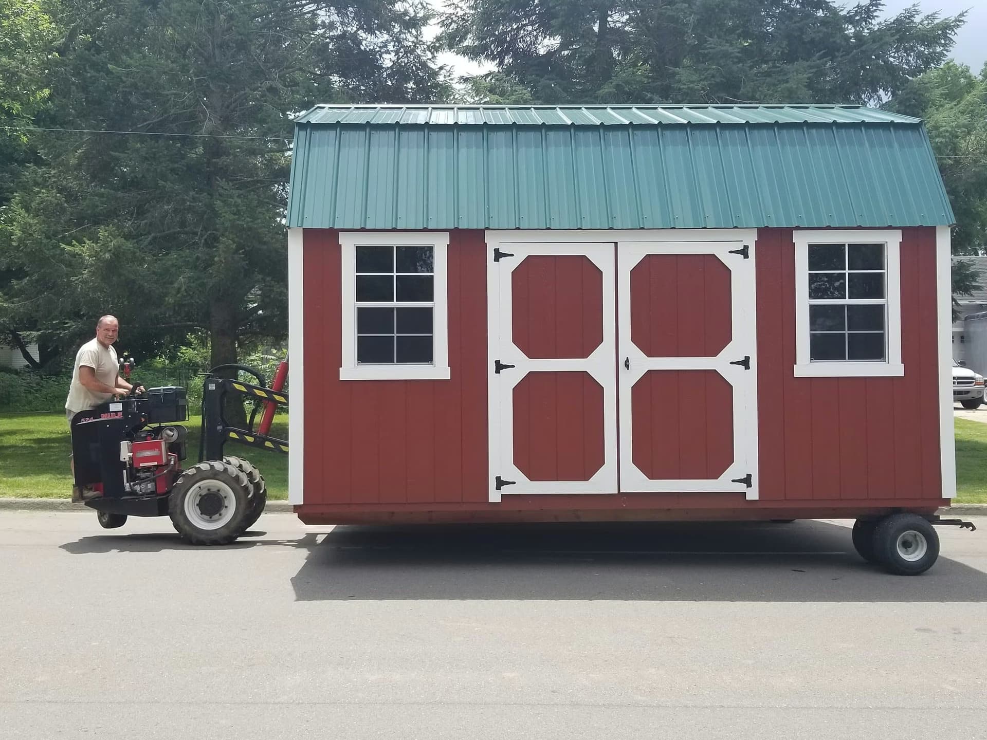 Amish Outdoor Buildings mule delivery placing a shed in a customer's backyard