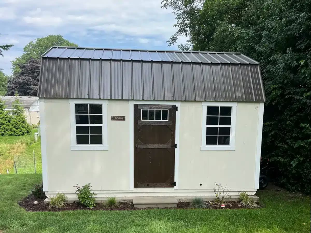 Amish-built lofted garden shed with flower beds on a Southern Michigan property