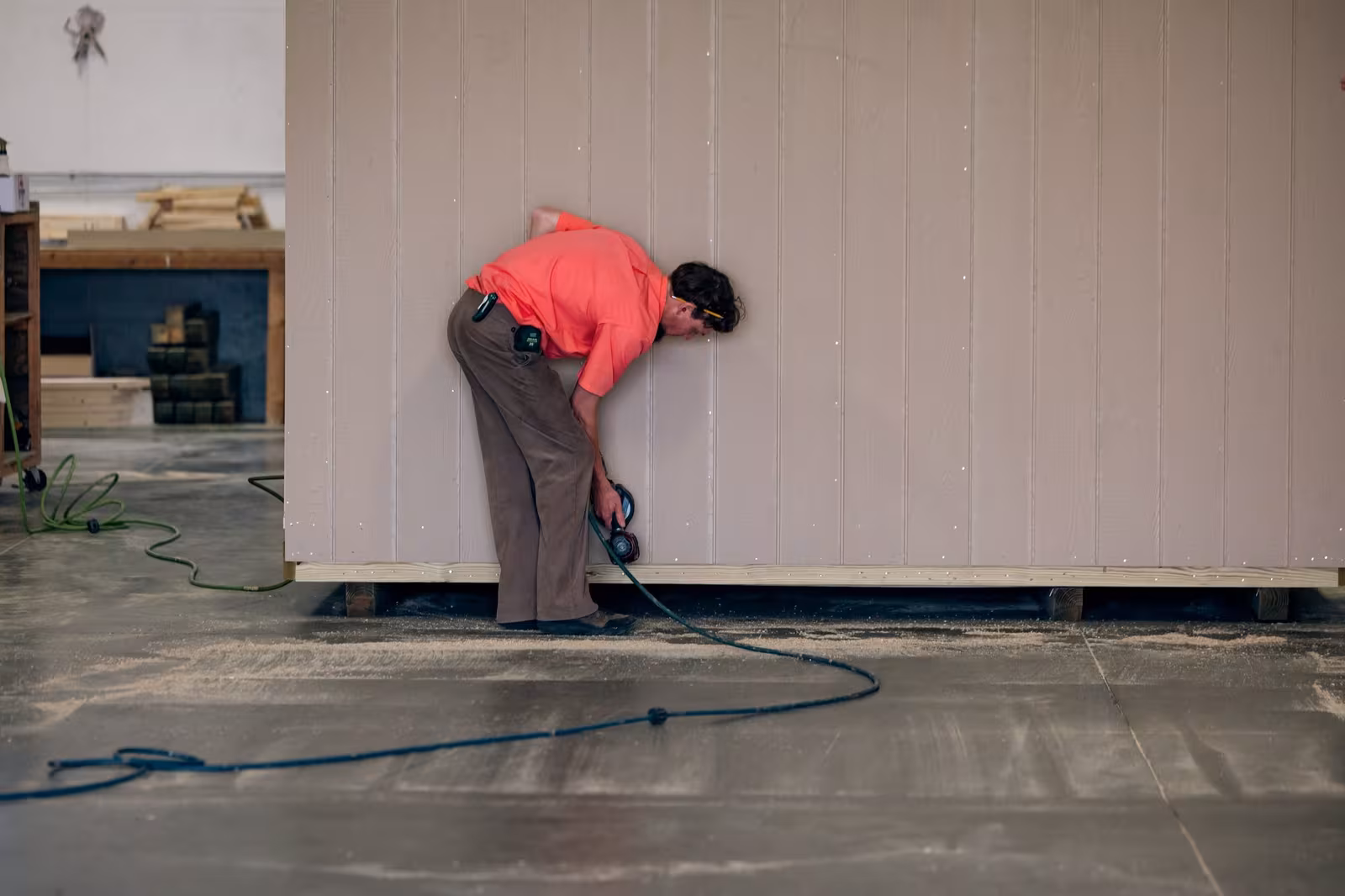 An Amish builder installing LP SmartSide siding on a shed