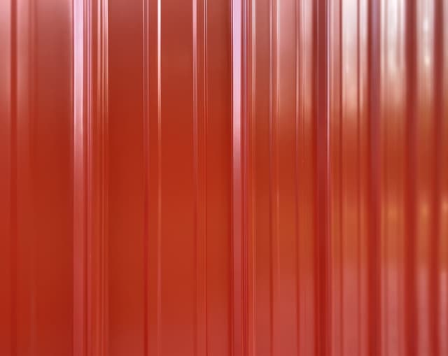 Painted vertical metal siding close-up