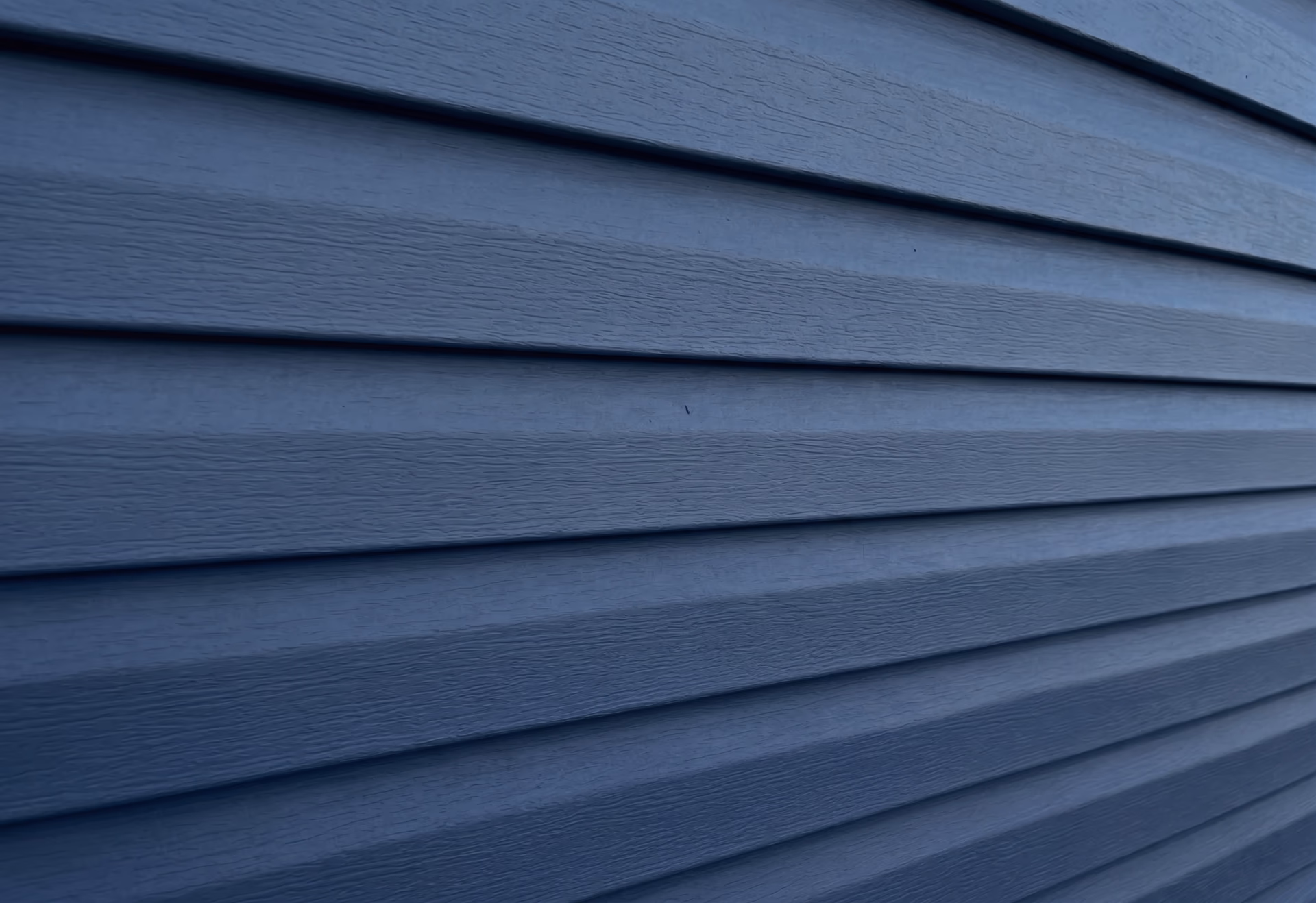 Navy horizontal vinyl lap siding close-up