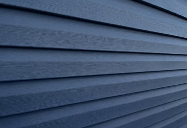 Navy horizontal vinyl lap siding close-up